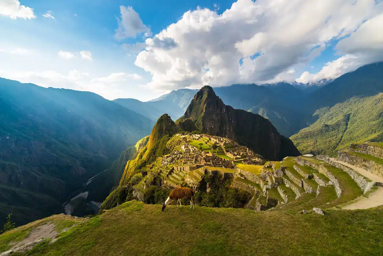 Panoramic view of Machu Picchu and the surrounding Andes mountains at sunset